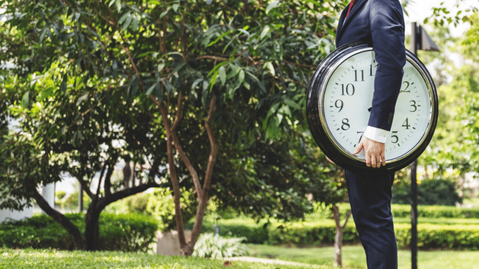 Man holding a clock